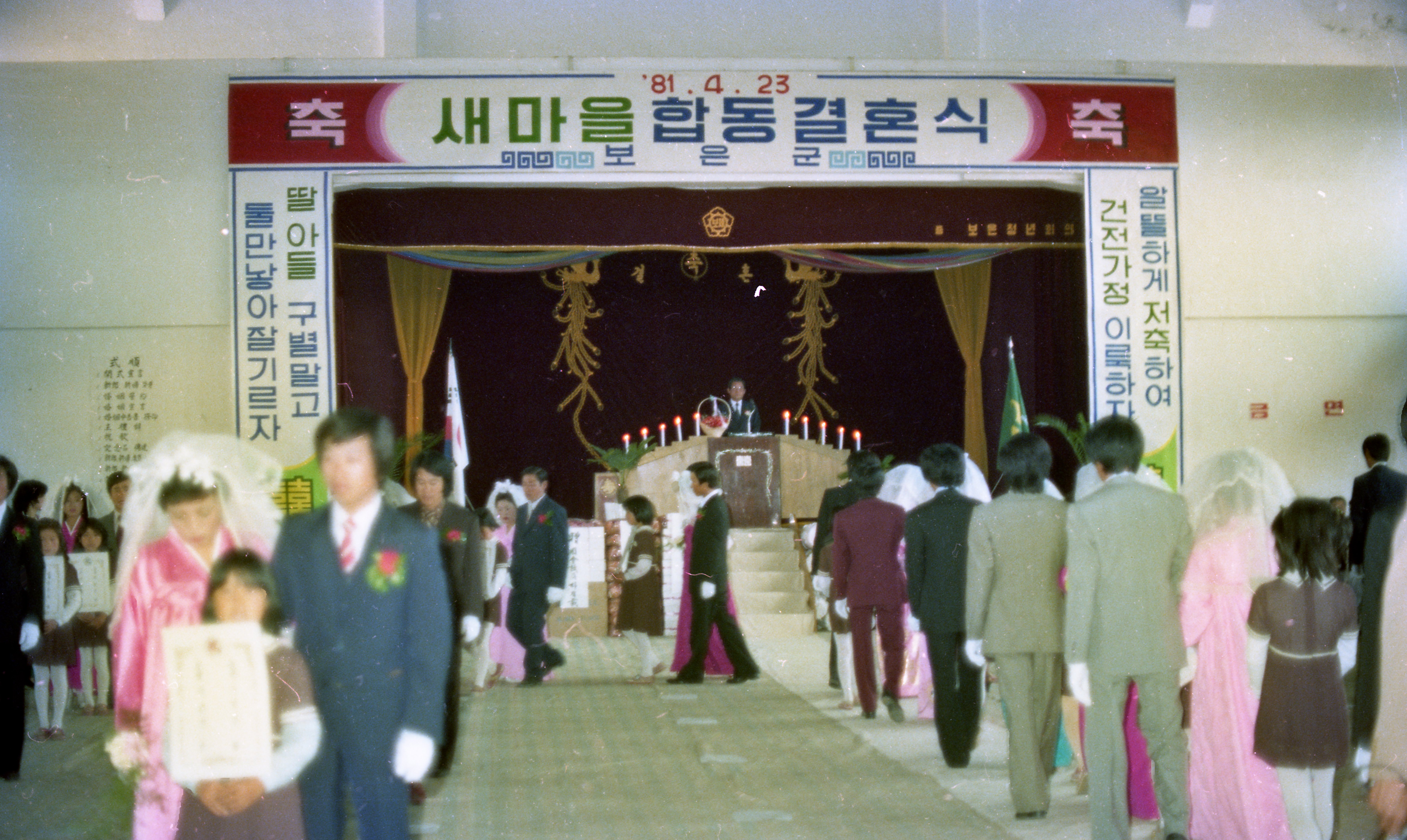 1981년 새마을 합동 결혼식 - 그 시절의 가정, 인구 정책을 볼 수 있는 표어가 눈에 띔 이미지